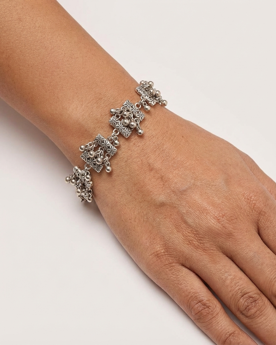 Oxidized Silver Floral Pattern Link Bracelet with Ghungroo Accents