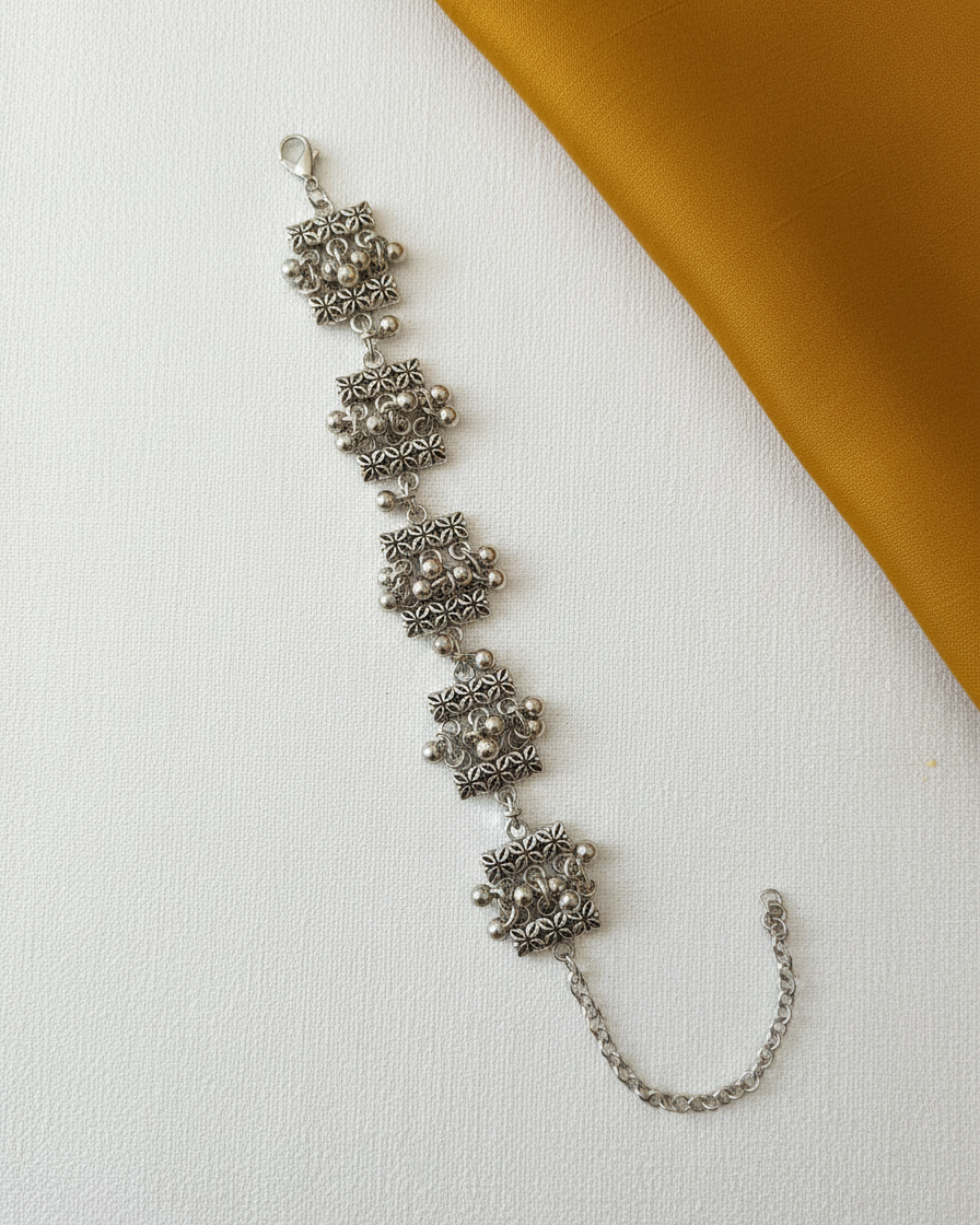 Oxidized Silver Floral Pattern Link Bracelet with Ghungroo Accents