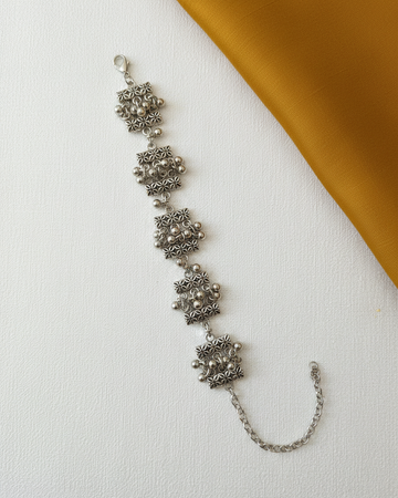 Oxidized Silver Floral Pattern Link Bracelet with Ghungroo Accents